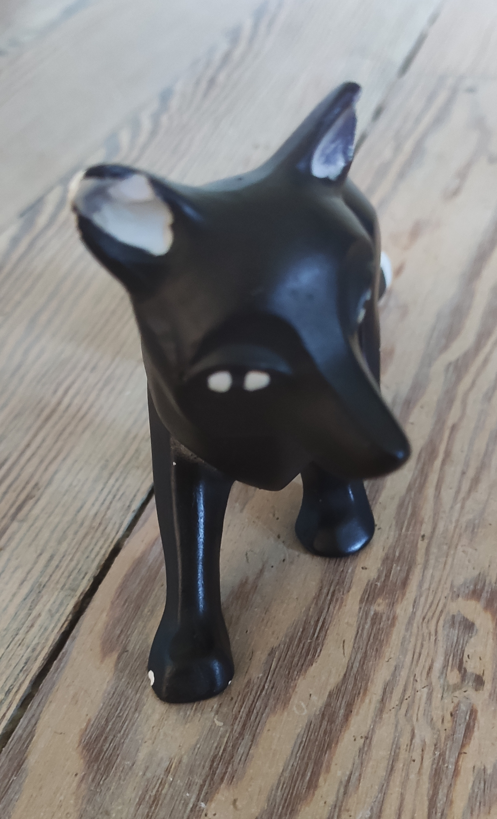 Front face shot of a fox figurine made of chalkware