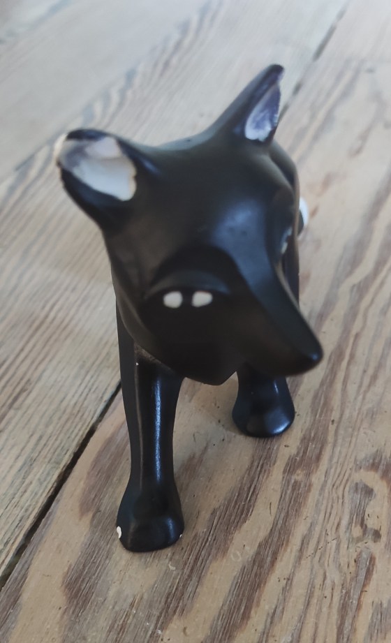 Front face shot of a fox figurine made of chalkware