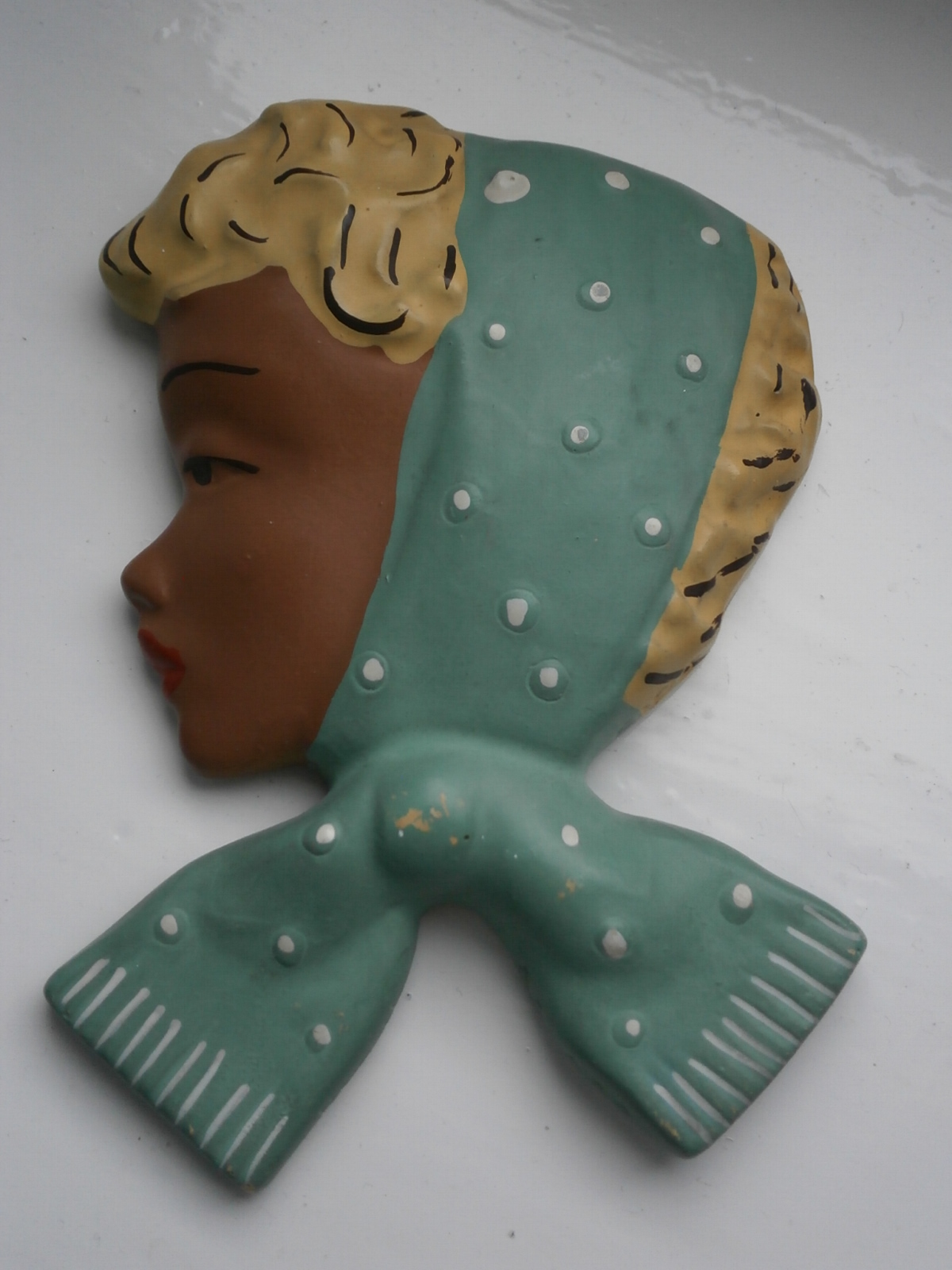 Wall plaque with green scarf