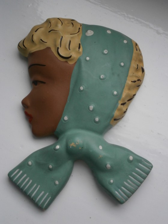 Wall plaque with green scarf