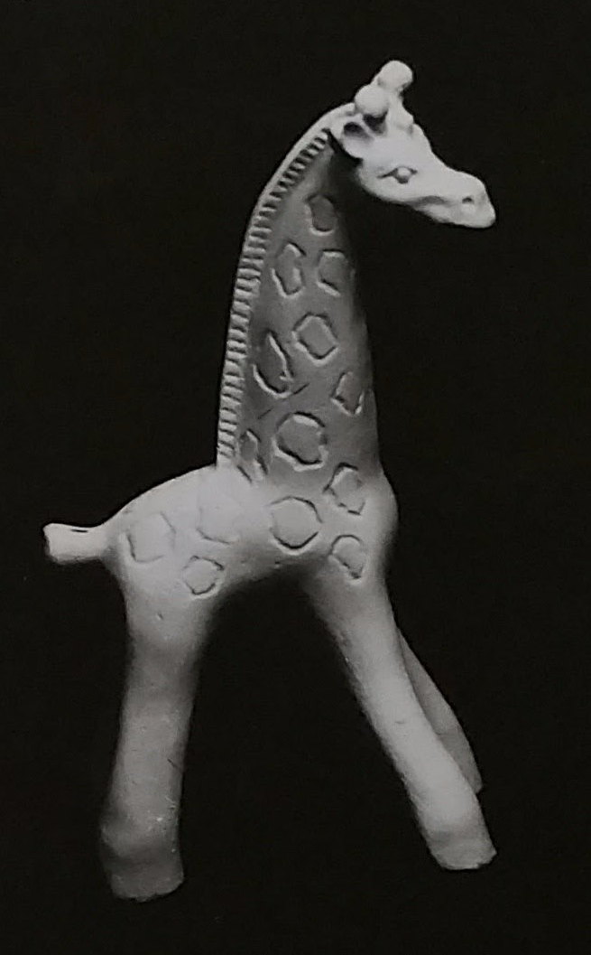 Raw chalkware figurine of a giraffe