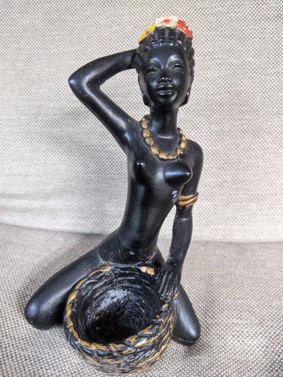 Kneeling lady with bowl figurine made of chalkware with flowers in her hair and gold embossed necklace