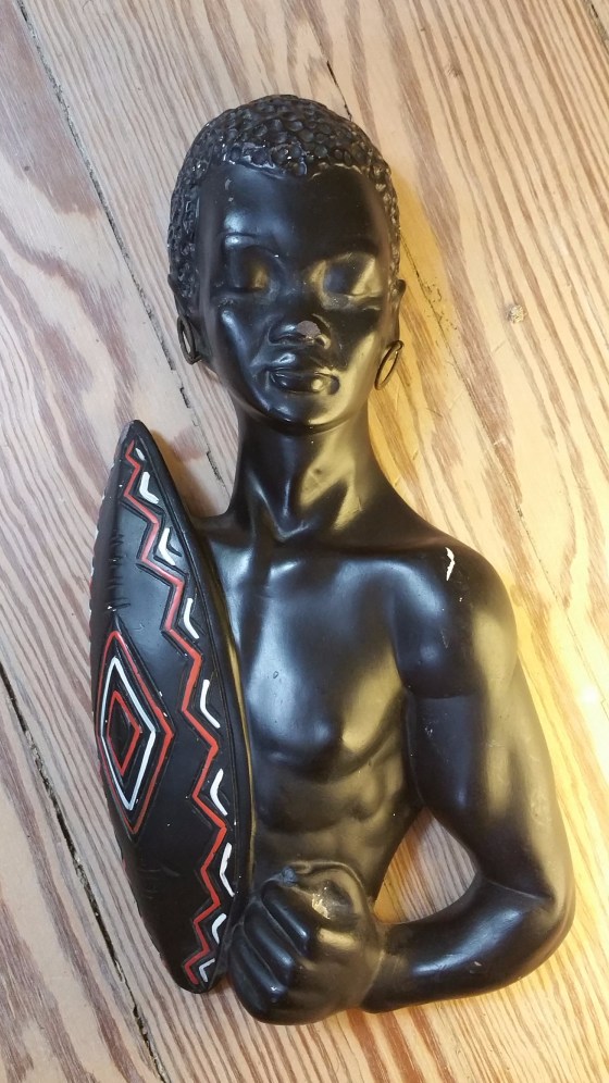 Black chalkware figurine wall plaque