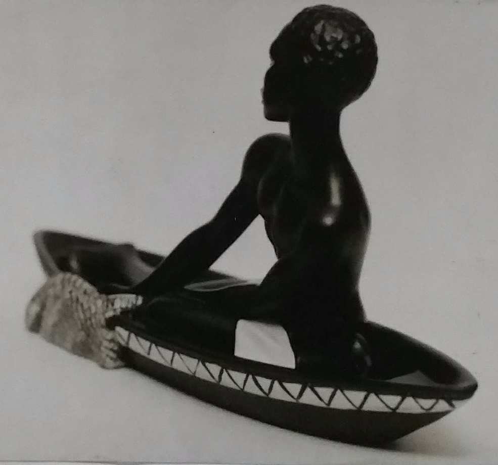 Black chalkware canoe figurine