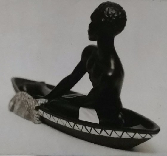 Black chalkware canoe figurine