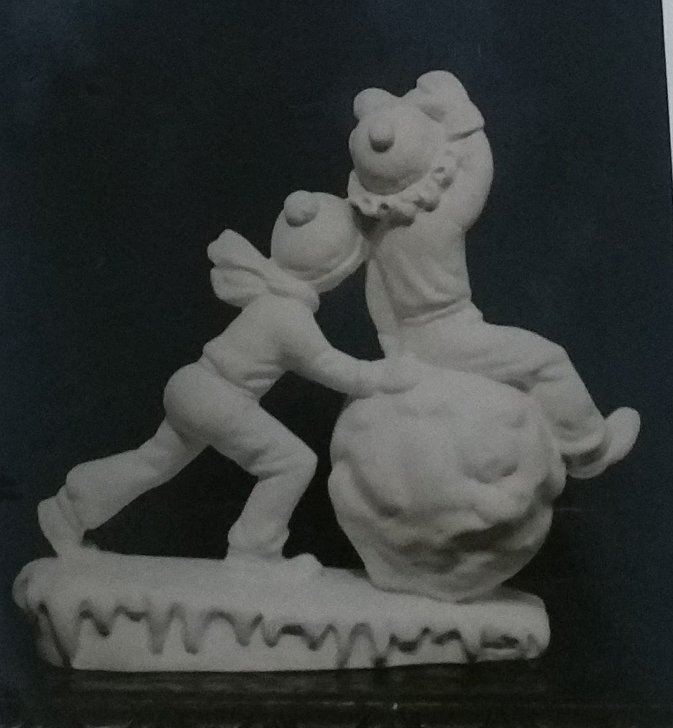 2 boys playing with snowball figurine