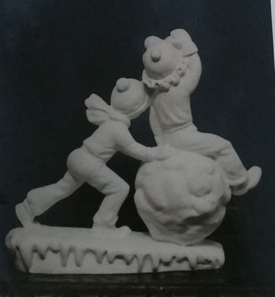 2 boys playing with snowball figurine