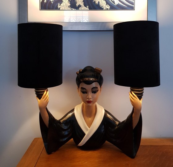 Lady chalkware lamp with black and white kimono. Lady is holding up both arms with light socket holders and large black cylindrical lampshades