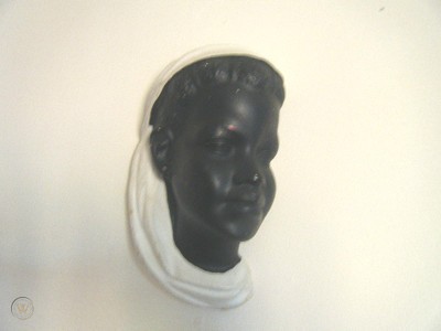 Black chalkware wall plaque