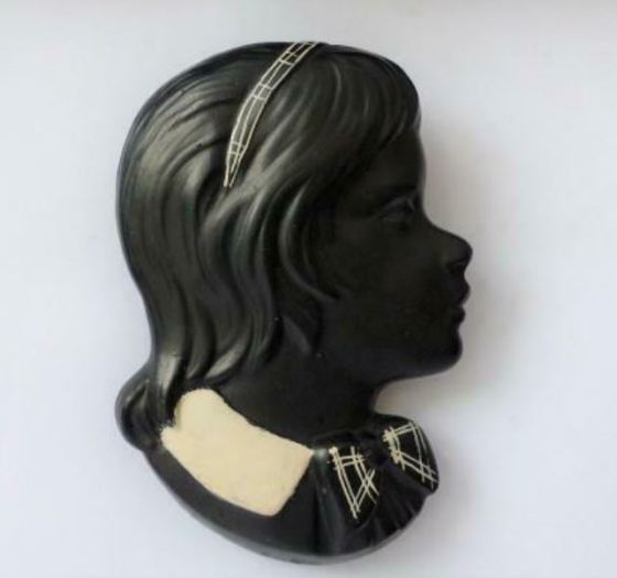 Black chalkware wall plaque