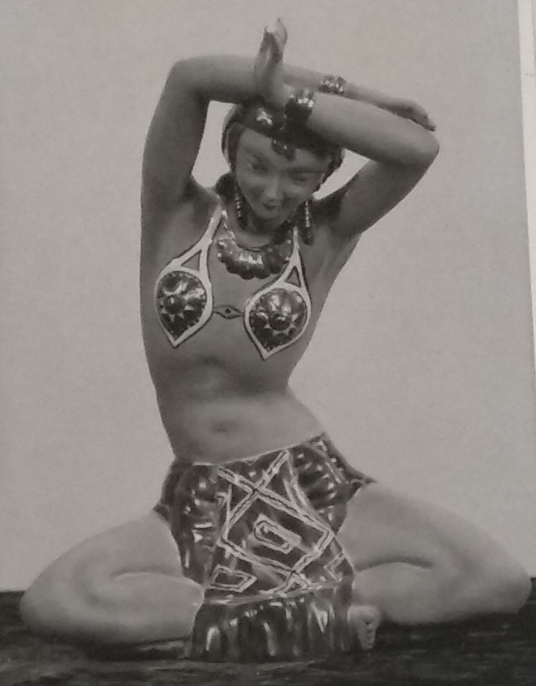 Chalkware figurine with arms above head