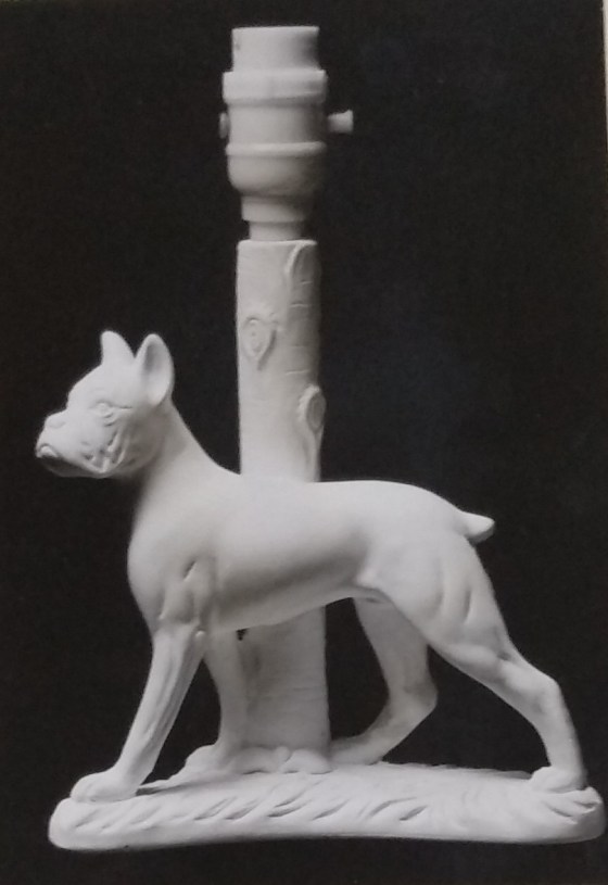 Bulldog standing in front of standard lamp