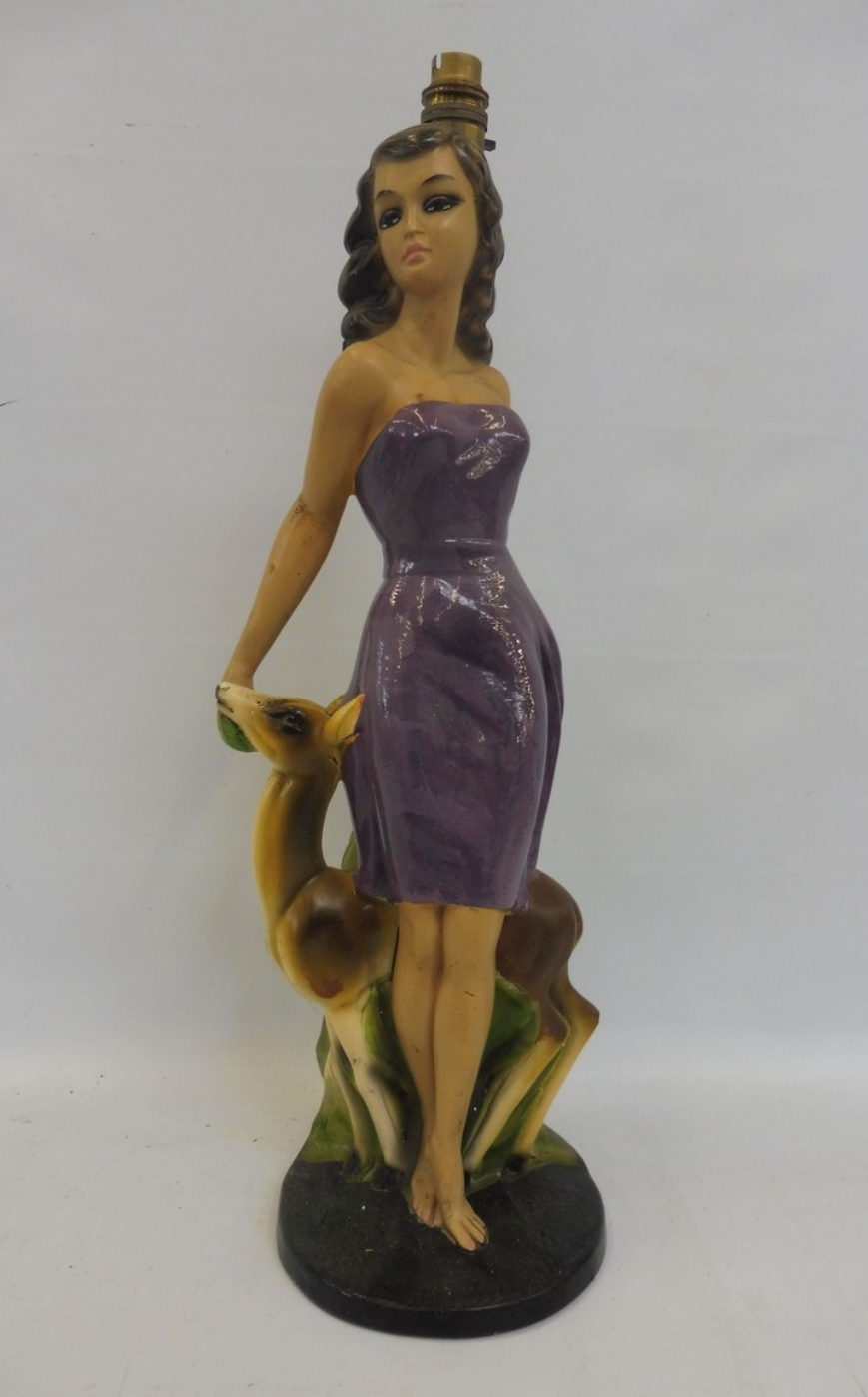 Chalkware lamp of a lady dressed in a purple above the knee dress and a small deer by her side