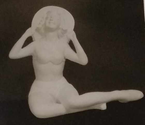 Girl figurine with large rimmed hat