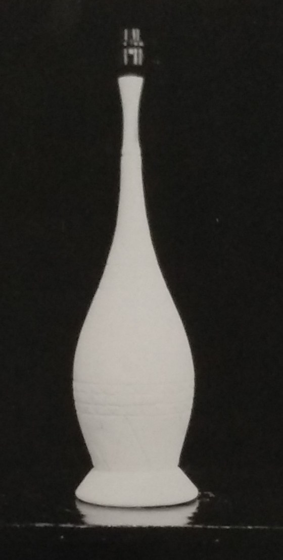 White standard lamp with thin neck going down to wider base