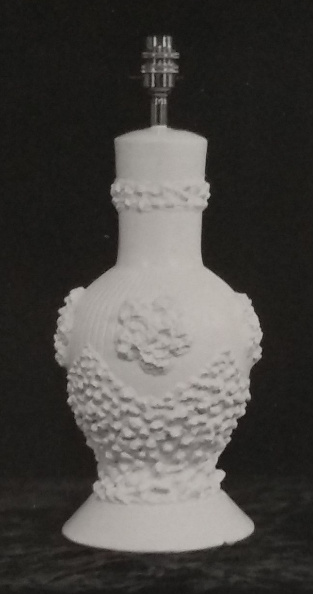 White standard lamp with raised patterns around the base