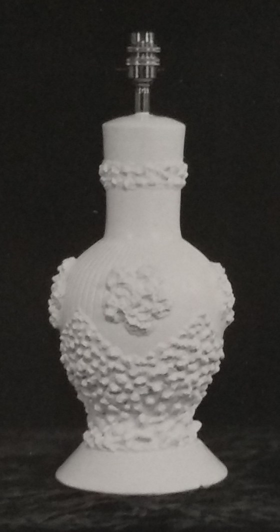 White standard lamp with raised patterns around the base