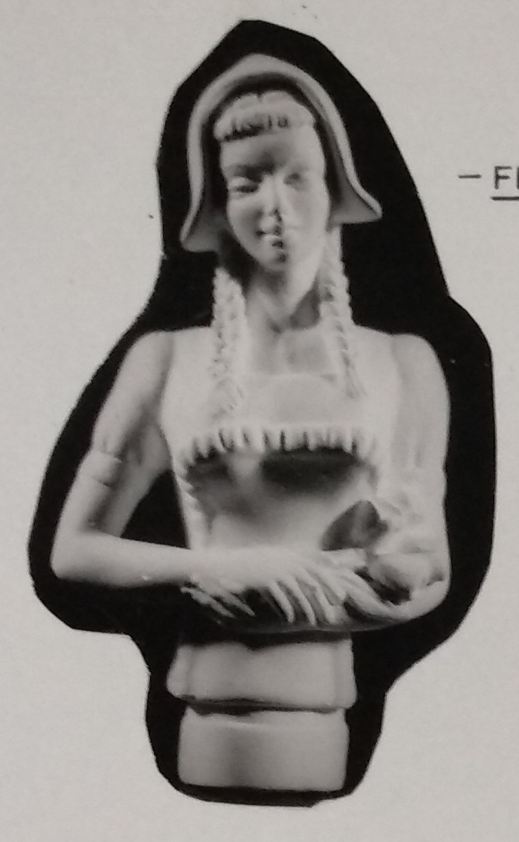 Lady figurine with hair in platts with hat on