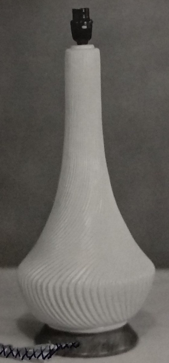 White standard lamp with light wavy lines