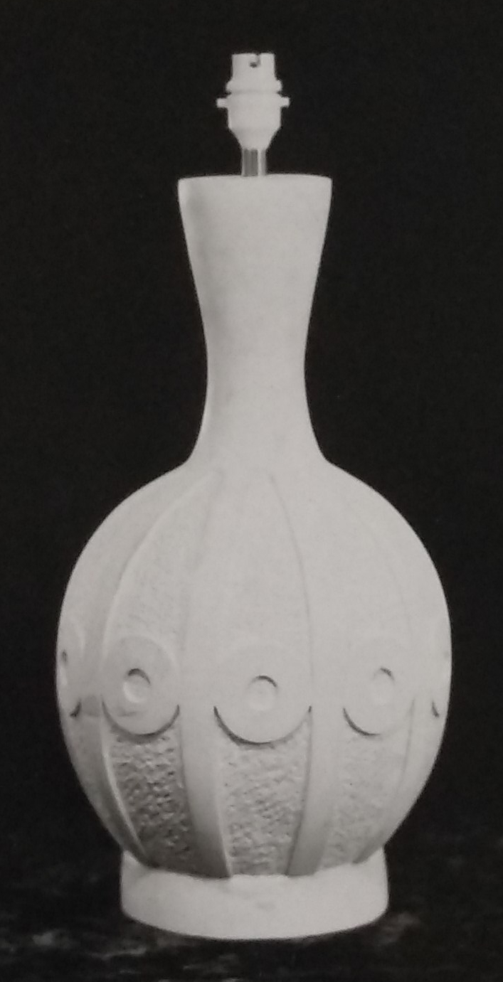 White standard lamp with circular patterns around the equator