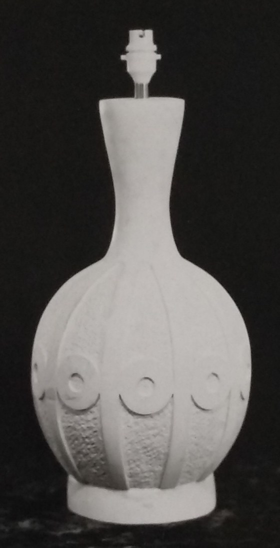 White standard lamp with circular patterns around the equator