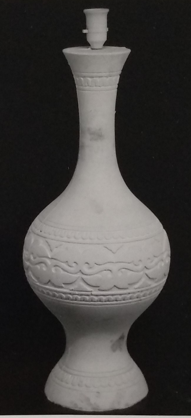 White standard lamp with simple etched carving around the centre