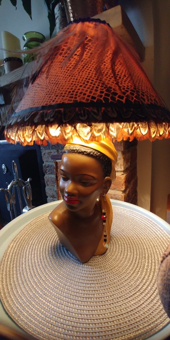 Chalkware lamp of a ladies head and shoulders wearing a head scarf