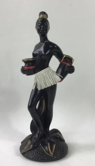 Chalkware figurine of a tall lady holding two vases