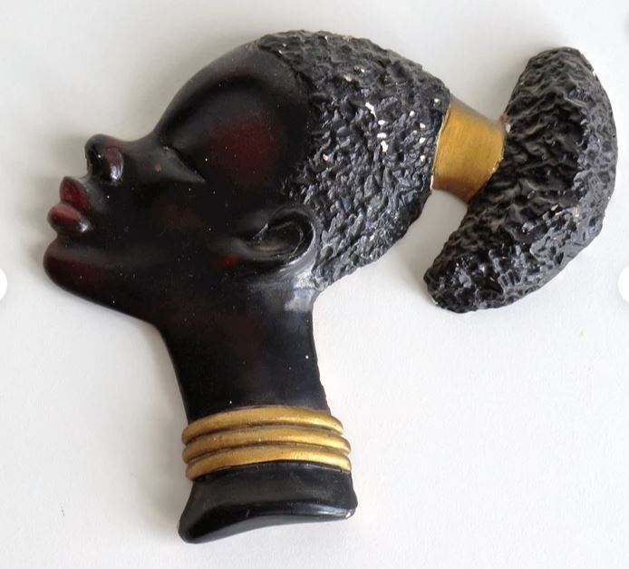 A piece of chalkware depicting a young african lady
