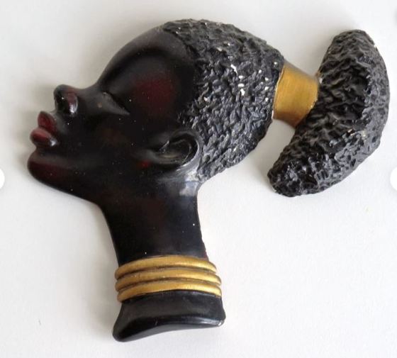 A piece of chalkware depicting a young african lady
